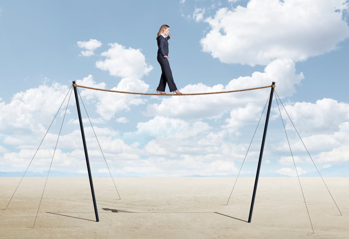 Businesswoman Balancing On Tightrope